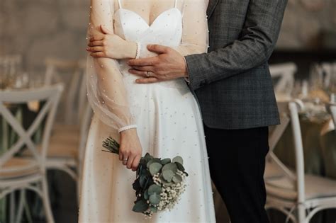 Premium Photo Groom Hugs Bride Waist