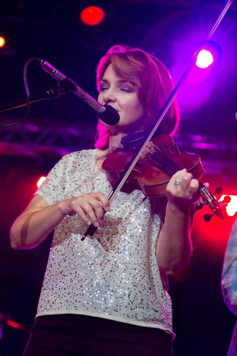 a woman playing the violin on stage