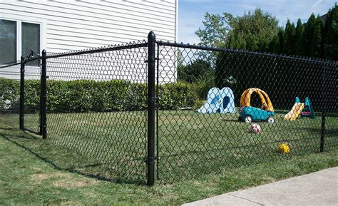 A black chain link fence around a small yard. | Black chain link fence, Types of fences, Chain ...