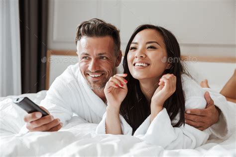 Multiethnic Couple Caucasian Man And Asian Woman Wearing White B Stock