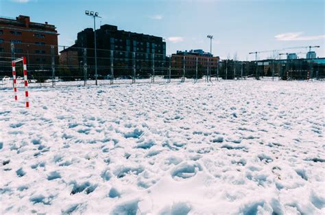 Football Field Covered with Snow Stock Photo - Image of buildings ...