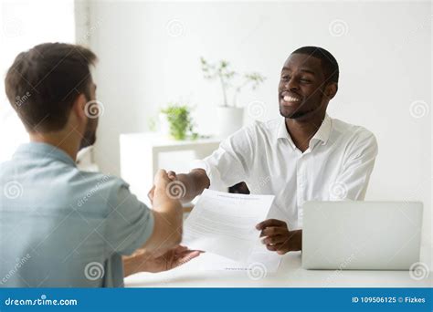 African Employer Handshaking New Hire Caucasian Employee Holding Stock Image Image Of Meeting