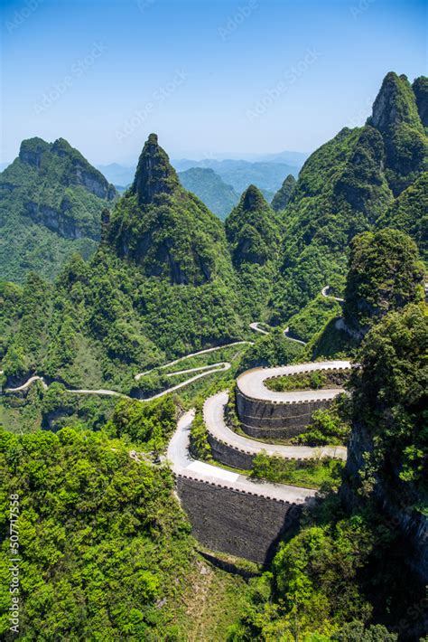 Sharp Peaks Covered With Forest And Close Up On The Layers Of The Road