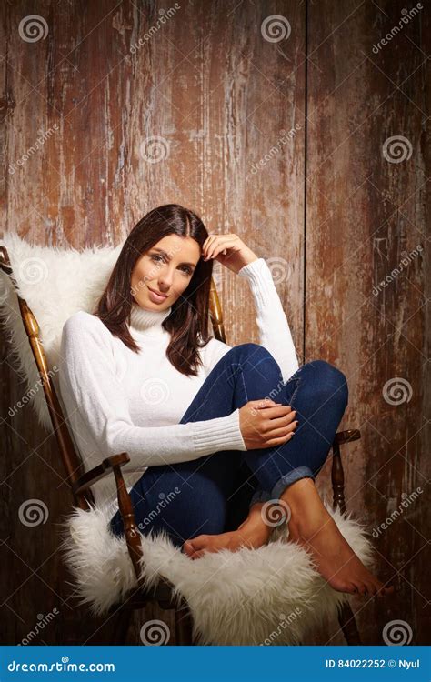 Young Woman Sitting in Chair Stock Photo - Image of brunette, female: 84022252