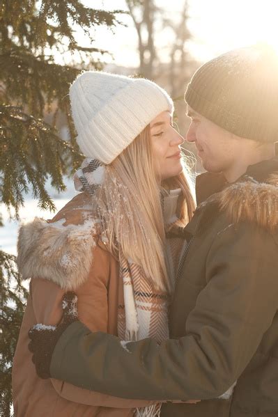 A Man And A Woman Looking At Each Other In The Winter Forest Stock