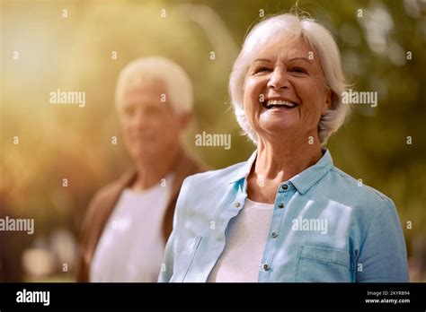Mature Senior Couple And Woman Portrait In Nature For Fun Bonding And