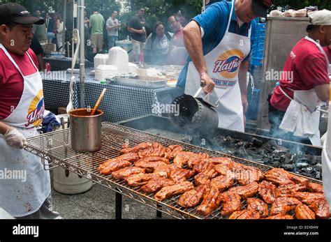 A Pit Boss Stirring Charcoal At New York Citys Big Apple Bbq Stock