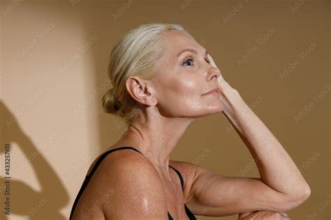 Foto De Studio Portrait Of Beautiful Mature Blonde Woman In Black Underwear Looking Away While