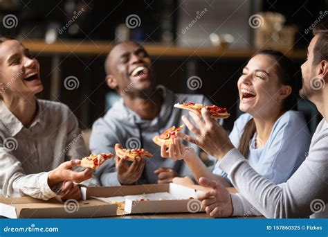 Diverse Friends Eating Pizza And Having Fun Together In Cafe Stock