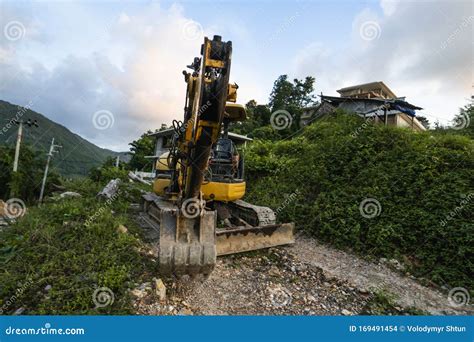 The Modern Excavator On The Construction Site With Sunset Sky Large