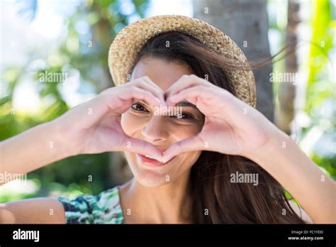 Smiling Beautiful Brunette Doing Heart Shape With Her Hands Stock Photo