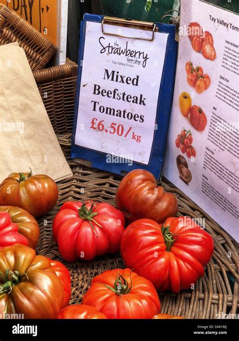 Mixed Beefsteak Tomatoes Priced Up For Sale At A Farmers Market Stall