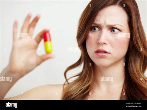 This tablet is way too big. A worried young woman looking at an ...