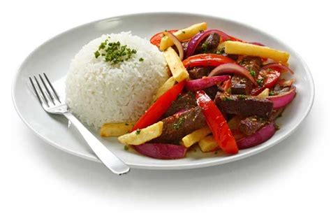 a white plate topped with rice and vegetables