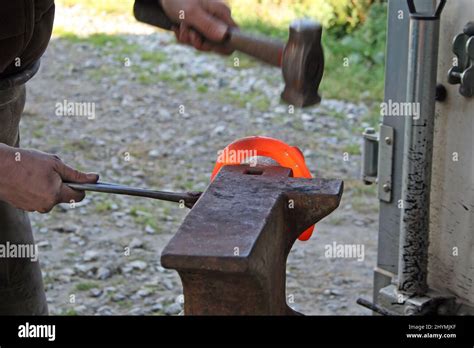Blacksmith Forges A Red Hot Iron In The Forge Stock Photo Alamy