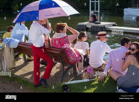 A Group Watch The Start Of A Race At Henley Royal Regatta Under A