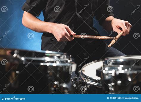 Close Up Of A Male Drummer S Hand Holding Drum Sticks While Sitting