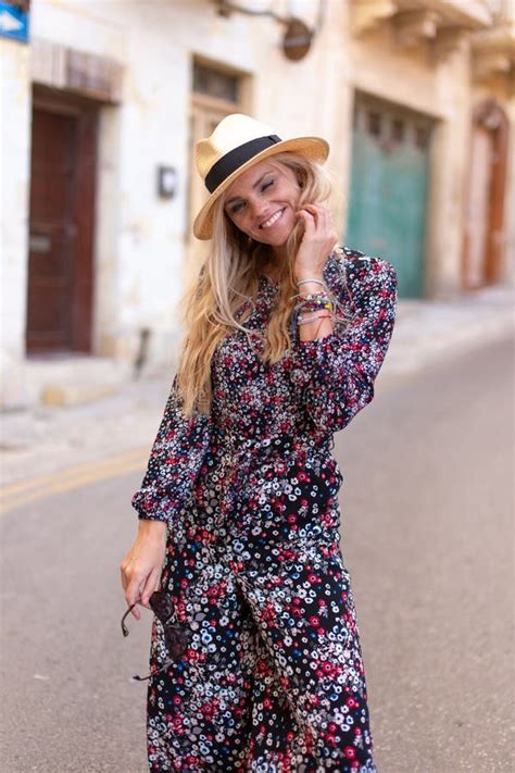 Blonde Mediterranean Woman Floral Pattern Dress Posing Stock Photo