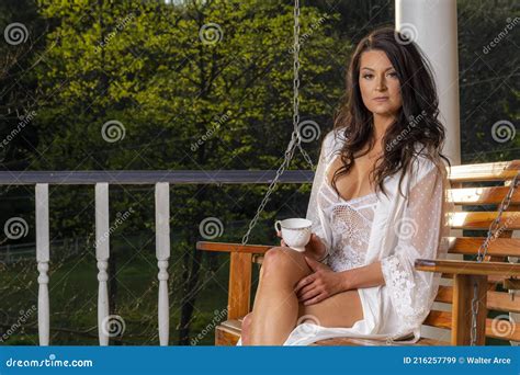 A Lovely Brunette Lingerie Model Enjoys Her Morning Coffee At Home Stock Image Image Of