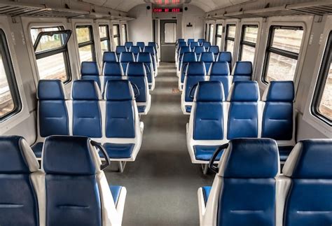 Premium Photo | Suburban train car interior, rows of blue chairs ...