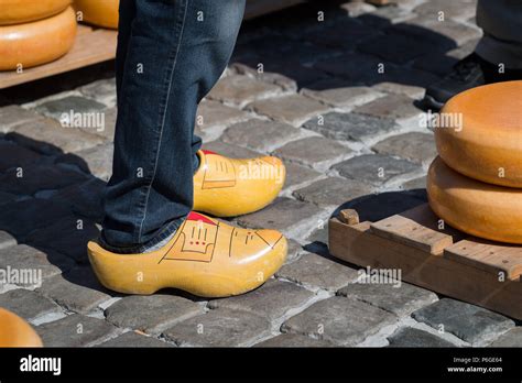 Traditional Dutch Clogs And Stacked Cheeses At The Gouda Cheese Market