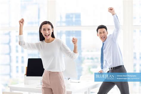 Confident Chinese Business People Cheering In Office High Res Stock