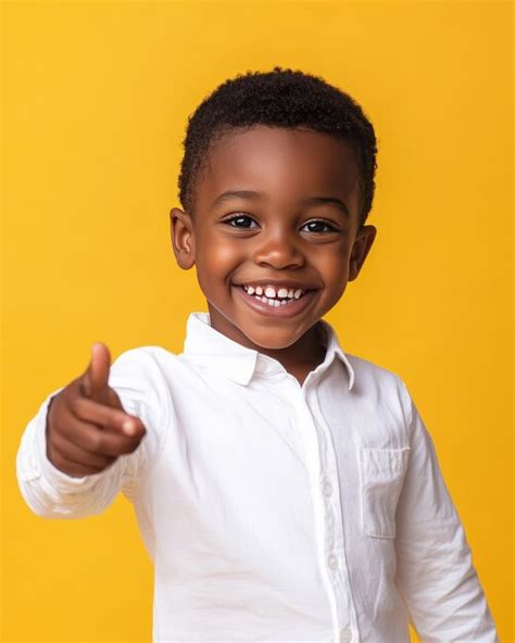 Happy African American Little Boy Showing Thumbs Up On Yellow