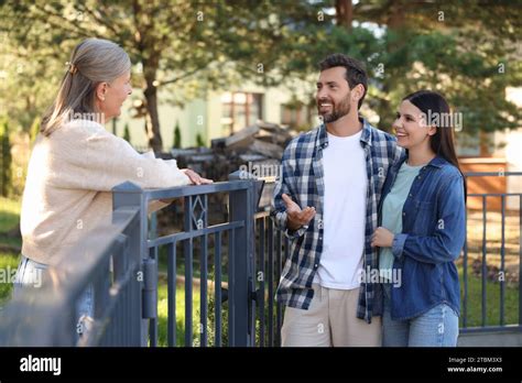 Friendly Relationship With Neighbours Happy Young Couple Talking To