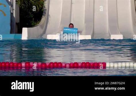 Girl Riding A Water Slide Happy Woman Going Down On Water Slide In The