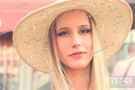 Portrait Of Attractive Smiling Blonde Woman With Straw Hat On