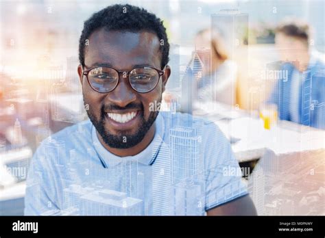 Positive Delighted Brunette Keeping Smile On His Face Stock Photo Alamy
