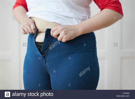 Woman Putting On Jeans High Resolution Stock Photography And Images Alamy