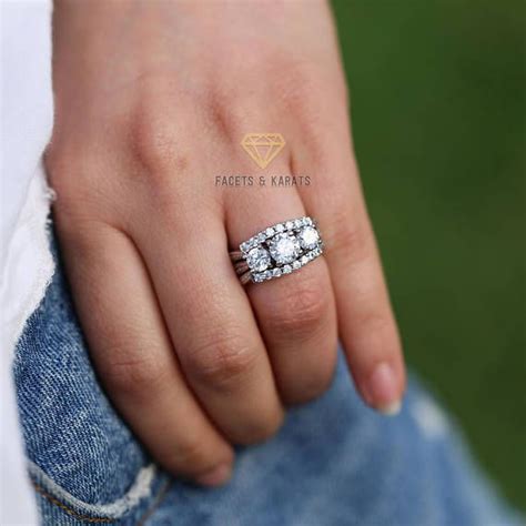 This Fine Three Stone Round Brilliant Cut Solitaire Engagement Ring