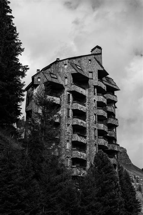 A Very Tall Building Sitting On The Side Of A Hill Photo Free Avoriaz