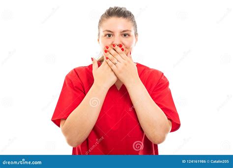 Young Medical Nurse Wearing Red Scrub Covering Mouth Stock Photo