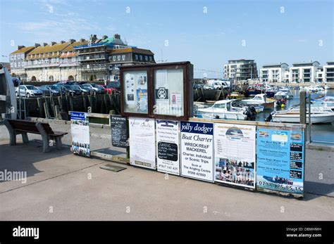 Signs And Posters Advertising Fishing And Pleasure Trips At West Bay