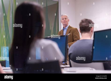 Handsome Mature Teacher And Students In Computer Lab Classroom Stock Photo Alamy