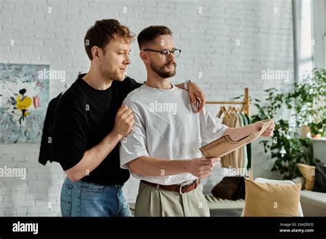 Two Men A Gay Couple Stand Side By Side In A Designer Workshop Passionately Creating Trendy
