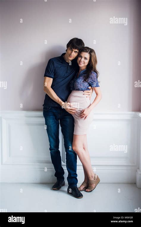 Man Kissing His Pregnant Wife And Touching Her Belly Stock Photo Alamy