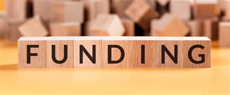 Premium Photo Funding Word Written In Wooden Cube Business Concept