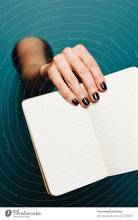 A Woman S Hand Holding An Empty Notebook A Royalty Free Stock Photo