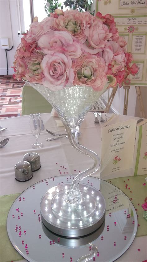 Twisted Martini Vase Weeding Centrepiece With Pink Roses Sitting On An