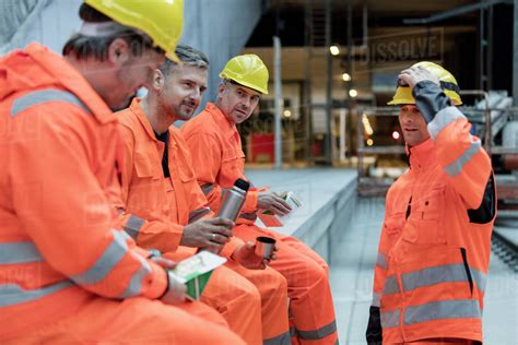 Construction Workers Eating Lunch At Construction Site Stock Photo