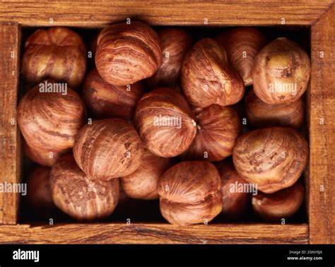 Hazelnuts In Wooden Box On Brown Wood Background Top View Filbert