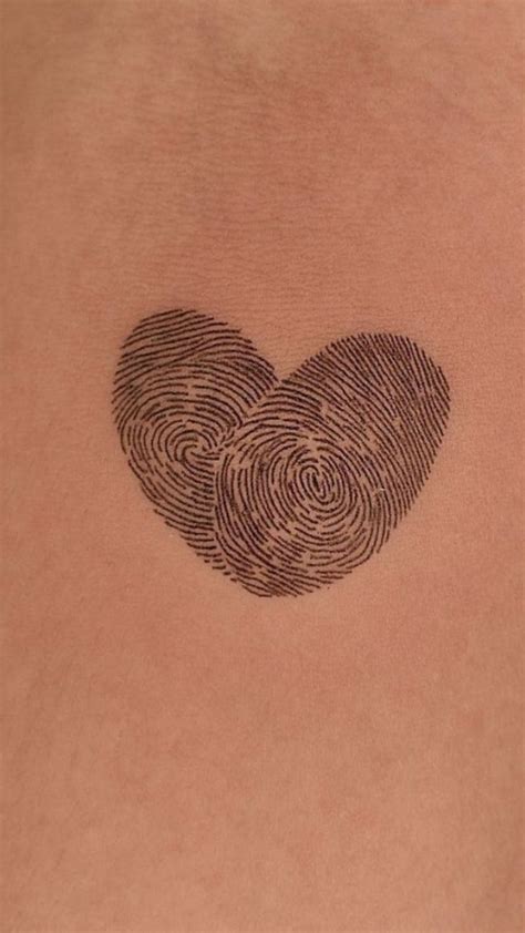 Two Fingerprints In The Shape Of A Heart On Someone S Back Shoulder