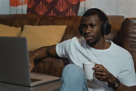 Man Using His Laptop while Having Coffee · Free Stock Photo