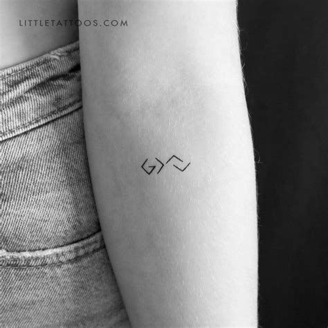 A Woman S Arm With A Small Tattoo On The Left Side Of Her Arm