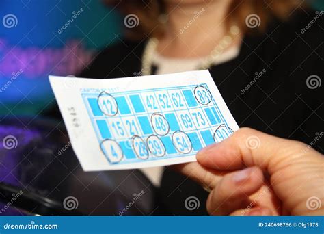 Person Playing Bingo Woman`s Hands Holding Cardboard From Bingo Game