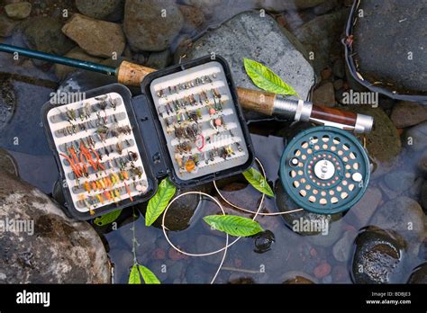 A Fly Rod Fly Reel Trout Fishing Net And Box Of Artificial Flies