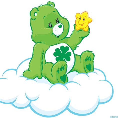 a green teddy bear sitting on top of a cloud with a star in its hand